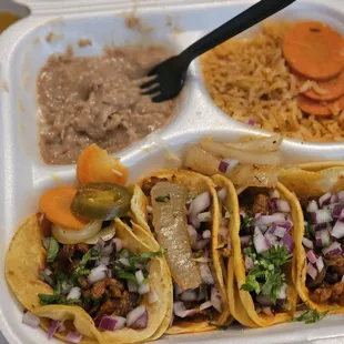Pastor Street tacos with all the same veg, on four white corn tortillas, rice, and beans.