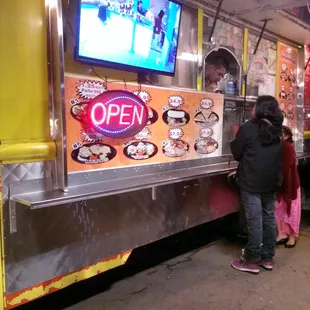 people ordering food from a food truck