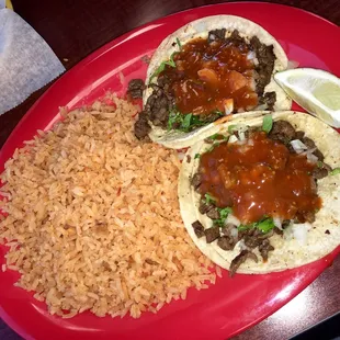 Carne asada tacos with a side of rice