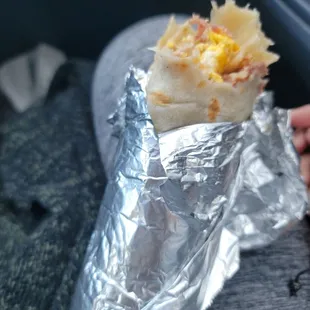 Breakfast Bacon egg  beans potatoes chesse burrito.  Breakfast Burrito