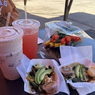 a woman sitting at a table with drinks