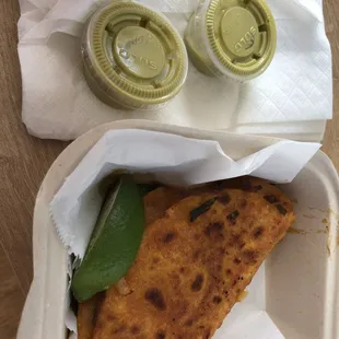 a slice of flatbread with a side of sauce