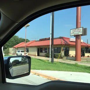 a view of a taqueria restaurant from a car window