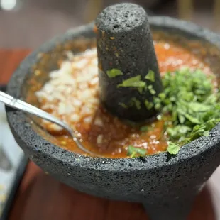 Made-to-order salsa served in a Molcajete