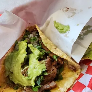 Taco de asada with guacamole on a regular corn tortilla
