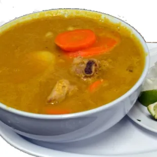 a bowl of soup and a side of rice