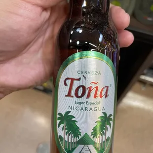 a person holding a bottle of beer