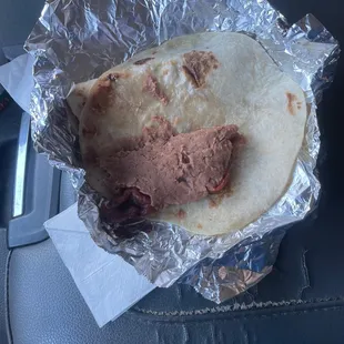 a taco wrapped in aluminum foil