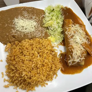 First half of the three item combo: pork tamal, rice, and beans