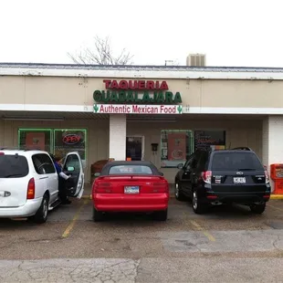 cars parked in front of a restaurant
