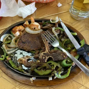 Steak and shrimp, peppers and onions.