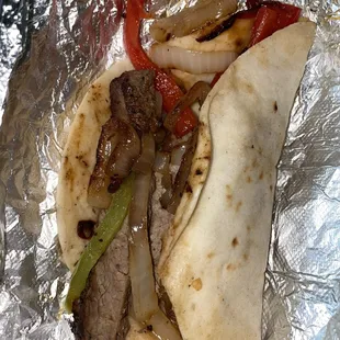a burrito with meat and peppers