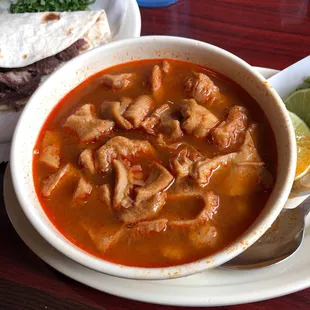  bowl of soup and a plate of tortillas