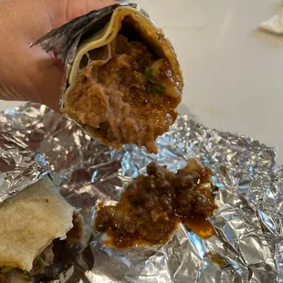 a hand holding a piece of food