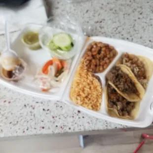 Tacos de buche y carne asada with arroz and beans. Very good and filling!