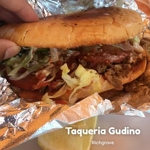 a hand holding a sandwich