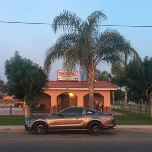 a car parked in front of a restaurant