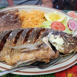 a plate of fish and rice