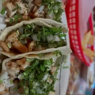 Chicken tacos with cilantro and onion