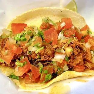 Tasty tinga taco on corn tortilla (shredded pork with chipotle)