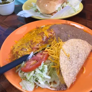 Torta de fajita de pollo and an enchilada, taco with refried beans