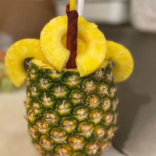 a pineapple in a pineapple cup