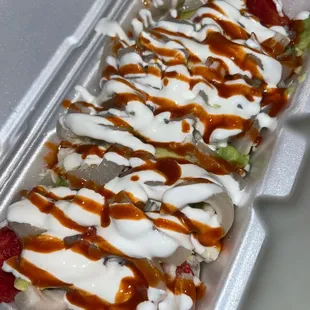 a tray of food with sauce and toppings