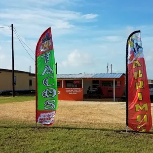 two flags in front of a building