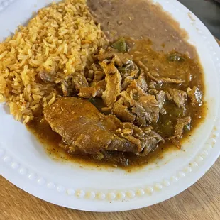 Pork and nopal in green salsa with rice and beans