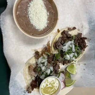 two tacos and a bowl of salsa