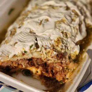 Pork belly and chorizo 2 meat wet burrito...sooooo good! Added my own sour cream at home.