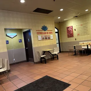 Another area and where restrooms are . Once again roomy, clean and lots of places to sit!!