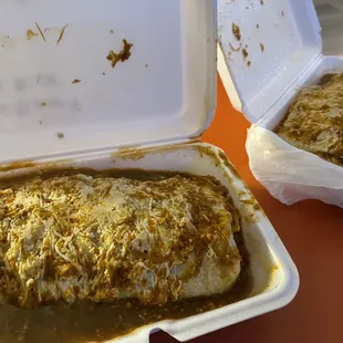 Wet burrito with red spicy sauce.