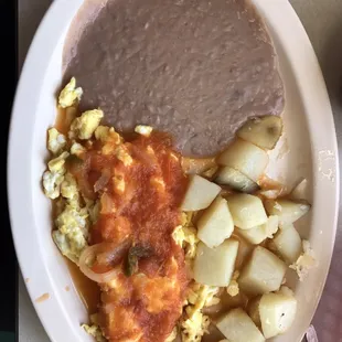 Decent huevos rancheros with a verrrryyyy thin layer of beans spread out on the plate. Portion control much?