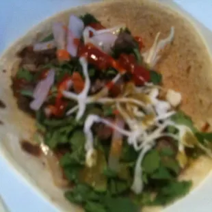 Beef fajita on handmade corn tortilla.