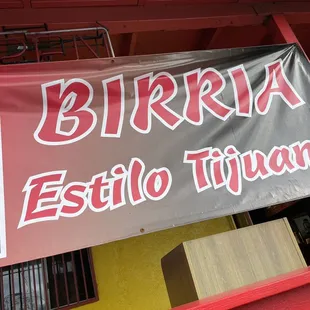 a sign for birria estilo titanas