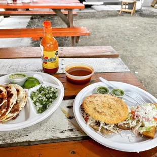 two plates of tacos and salsa