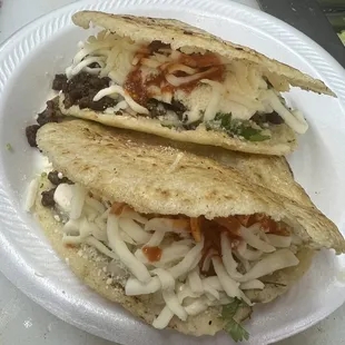 two tacos on a paper plate