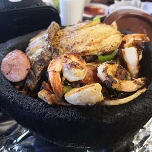a black stone bowl filled with food