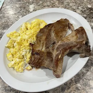 Two scrambled eggs and a pork chop - The scrambled eggs are alright, but the pork chop is delicious !!!