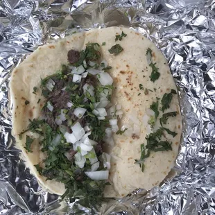 a taco with onions and herbs