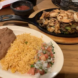 Shrimp, chicken and beef fajitas with rice beans and homemade corn tortillas
