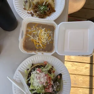  two plates of tacos and a salad