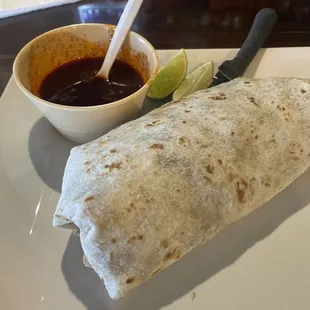 Large steak burrito with a side of Birria consommé for dipping. $7