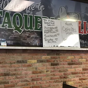 a sign on a brick wall