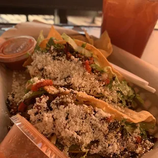 a plate of tacos and a drink