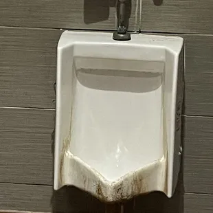 a urinal in a public restroom