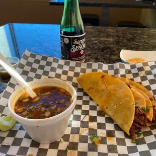 a plate of tacos and a drink