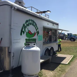 a taqueria truck parked on the side of the road