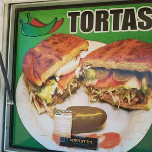 a sandwich and pickle on a plate